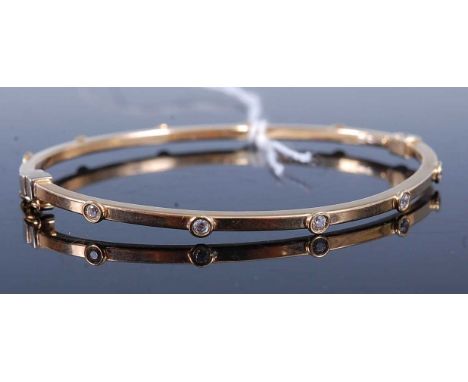 A contemporary 9ct gold and CZ set hinge bangle 4.7g, dia. 6.5cm, in leather case