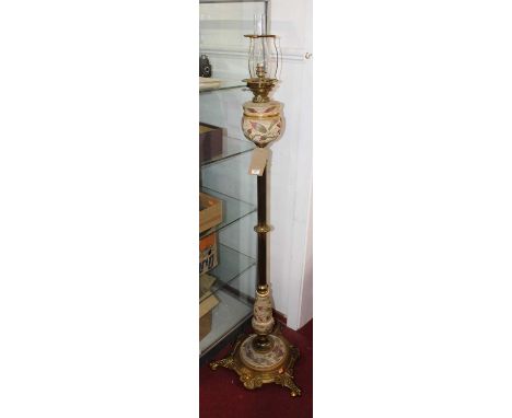 An early 20th century brass standard lamp, converted from oil, the reeded column above a swept base with squirrel and beaded 