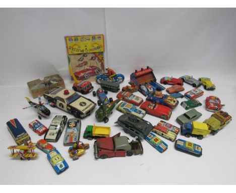 A collection of assorted Japanese, German, English and other tinplate vehicles including Arnold A-680 clcokwork tank (missing