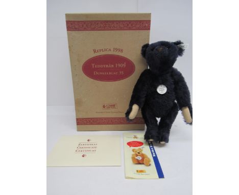 A boxed Steiff limited edition 406508 Teddy Bear 1909 Replica, the articulated dark blue mohair bear with plastic eyes, stitc