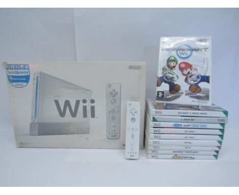 A boxed Nintendo Wii computer games console with additional controller and ten games to include Mario Kart, Just Dance 3, Jus