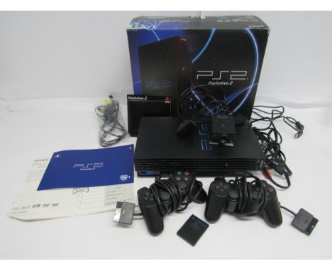A boxed Sony Playstation PS2 computer games console with two controllers, eye toy, leads, demo disc and manuals 