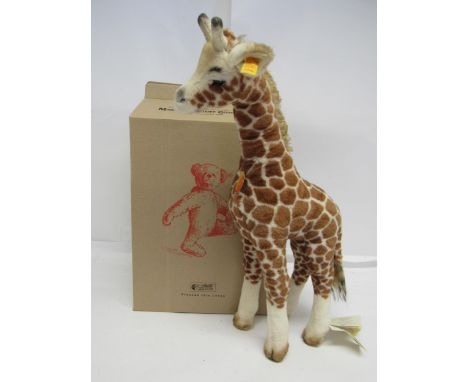 A boxed Steiff 068089 Giraffe with gold coloured button and yellow tag to ear, chest tag and swing tag to leg, 48cm tall