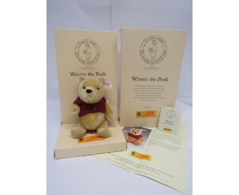 A boxed Steiff limited edition 680090 75th Anniversary Winnie The Pooh articulated mohair teddy bear with black plastic eyes,
