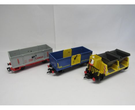 Three unboxed items of Playmobil G scale garden railway rolling stock to include 4116 Tipper Wagon in yellow, 4114 Open Freig