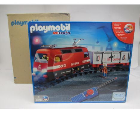 A boxed Playmobil 4010 G scale RC Train set, comprising locomotive and wagon in red and grey PM train livery, track, points a