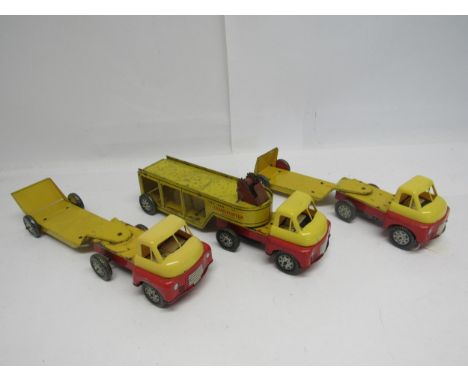 Three Wells Brimtoy clockwork tinplate articulated vehicles to include two low-loaders (one lacking motor) and toy car transp