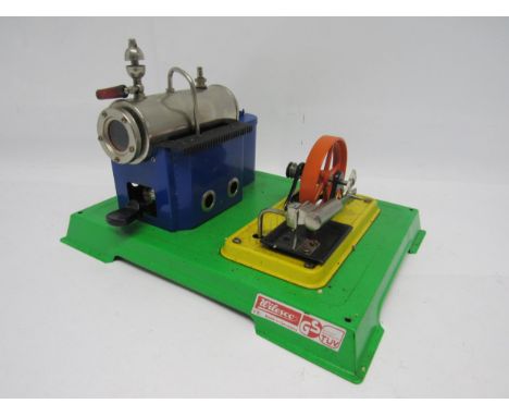 A Wilesco D8 live steam stationary engine plant, the horizontal boiler raised on blue tinplate plinth, powering single cylind