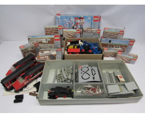 A collection of boxed 1980s Lego railway sets and accessories to include 7866 level crossing, 7864 12 volt transformer, 7863 