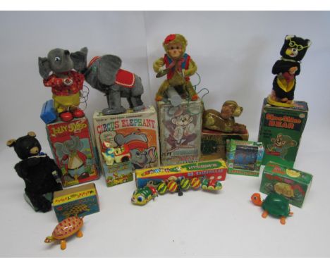 A collection of boxed Japanese tinplate, plastic and plush covered clockwork and battery operated novelty toys to include Cra