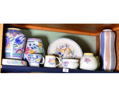 A shelf of various Poole pottery