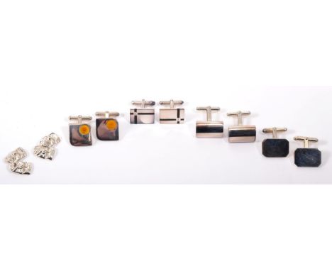 A pair of silver diamond and enamel cufflinks, rectangular tops inset with a round brilliant cut diamond to a black enamel cr