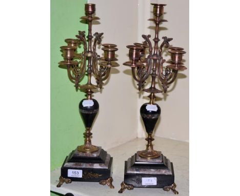 A pair of black slate and marble gilt metal mounted five light candelabra