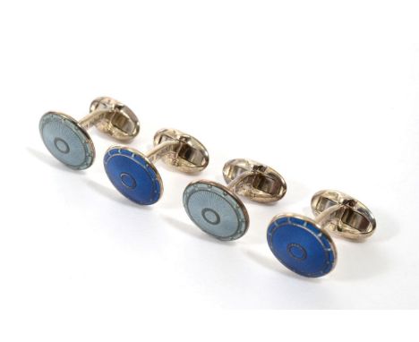 A pair of silver blue guilloche enamel cufflinks, circular heads to hinged solid bars and a matching green guilloche enamel p