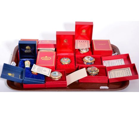 A collection of twelve Halcyon Days enamel trinket boxes comprising a year run of Christmas boxes from 1987-1996 and two flor