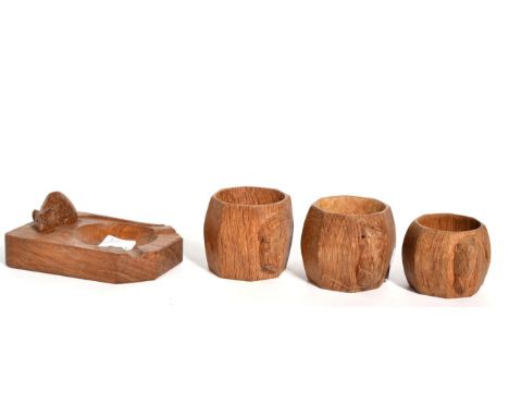 Three Robert 'Mouseman' Thompson napkin rings and a Mouseman ashtray