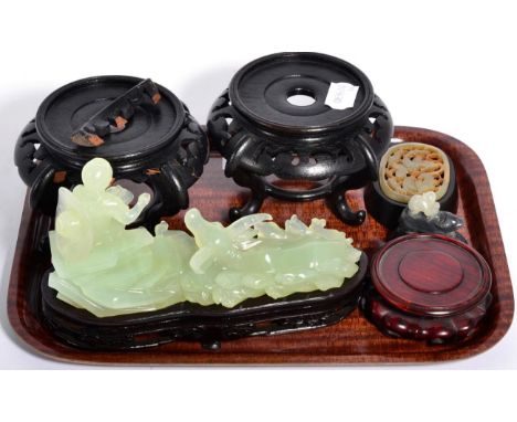 Three pieces of Chinese carved hardstone including a jade plaque decorated with an insect and a group of hardwood stands