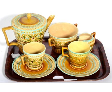 A group of Linthorpe pottery tea wares, including a pair of tea cups and saucers shape No.1899, decorated with floral sprigs 