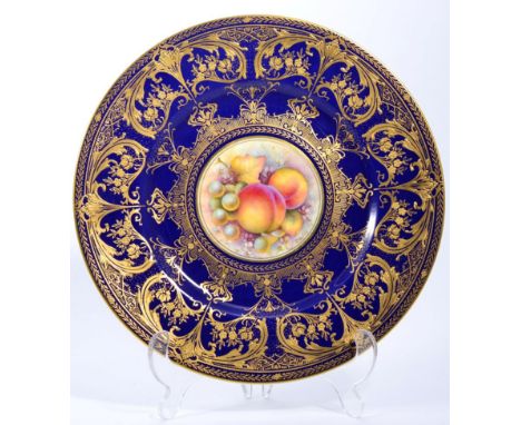 A Royal Worcester fruit painted plate with blue and gilt border signed C Hughes, 27cms Good condition
