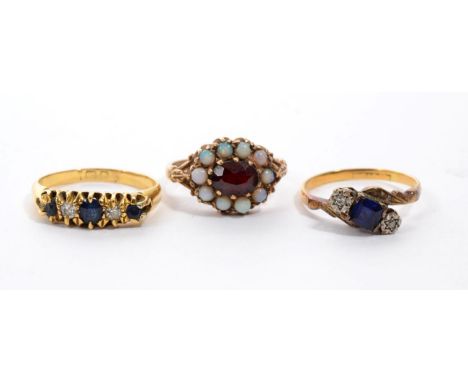 An 18 carat gold sapphire and diamond five stone ring, two old cut diamonds spaced by round cut sapphires in a carved setting