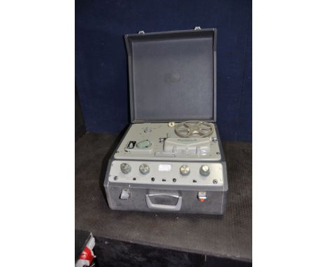 A VINTAGE FERROGRAPH REEL TO REEL PLAYER in a grey case (PAT fail due to uninsulated plug but reel drives forwards and backwa