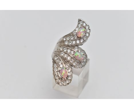 A WHITE METAL DRESS RING, large dress ring set with colourless cubic zirconia and three synthetic opals, stamped 925, ring si