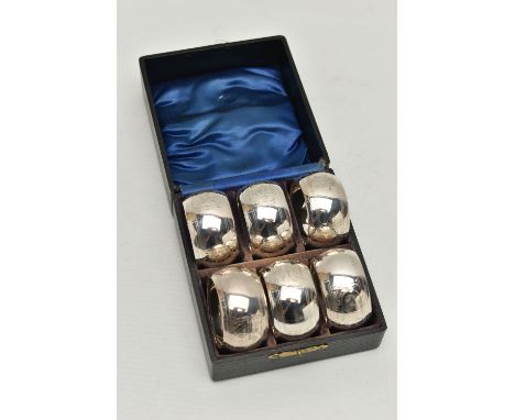 A CASED SET OF SIX GEORGE V CIRCULAR SILVER NAPKIN RINGS, foliate engraved decoration, vacant cartouches, maker Samuel M Levi
