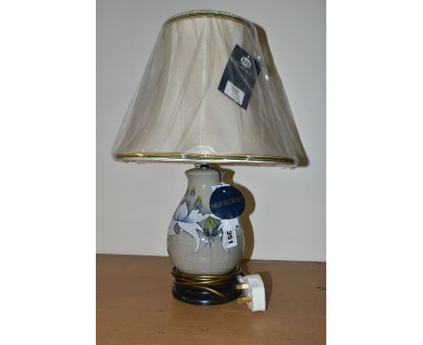 A MODERN MOORCROFT POTTERY TABLE LAMP WITH SHADE, the lamp decorated with waterlily style flowers on a sage green ground, tag