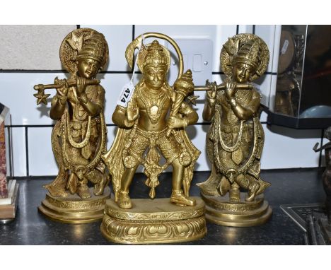 THREE GILT METAL RELIGIOUS HINDU FIGURES, comprising Lord Hanuman, height 30cm, and two figures of Lord Krishna playing a flu