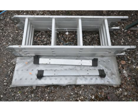 AN ALUMINIUM FOUR-FOLD MULTI PURPOSE LADDER, with a platform (condition: -missing bolts to ladder support)