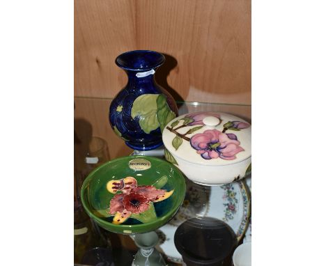 THREE PIECES OF MOORCROFT POTTERY, comprising a Magnolia pattern covered pot, a Clematis vase height 13cm, and a footed bowl 