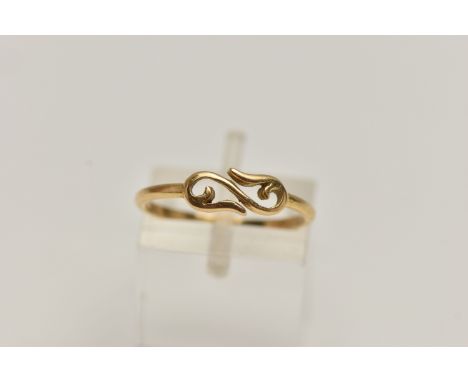 A RING, designed with a scrolling central panel, to the thin band, with French assay mark, ring size M 1/2, approximate weigh