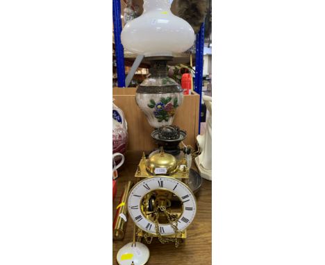 AN OIL LAMP, square brass base with a ceramic reservoir decorated with applied flowers, white glass shade (missing chimney), 