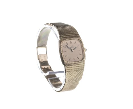 LADY'S OMEGA NINE CARAT GOLD MANUAL WIND WRIST WATCH, the cushion shaped gold coloured dial with applied baton hour markers, 
