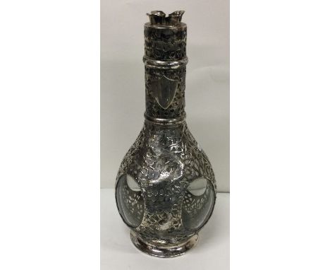 A large silver mounted glass wine decanter of Chinese design decorated with dragons and temples. Marked to base. Est. £200 - 