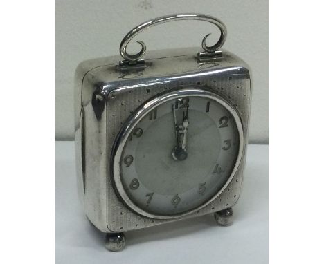 A novelty engine turned silver clock. Birmingham 1913. By William Neale Ltd. Approx. 264 grams. Est. £200 - £300.