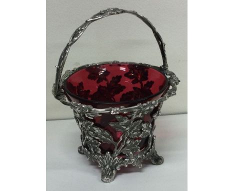 A large Victorian silver basket with red glass liner. London 1877. By Barnards. Approx. 219 grams. Est. £400 - £600.