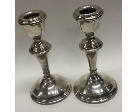 A pair of circular silver candlesticks. Birmingham. Approx. 409 grams. Est. £40 - £60.