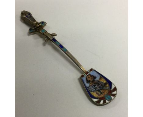 An unusual silver and enamel hinged spoon decorated with pyramids and a mummy. Approx. 10 grams. Est. £60 - £80.