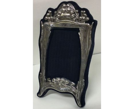 A large decorative silver picture frame. Marked Sterling. Est. £60 - £80.