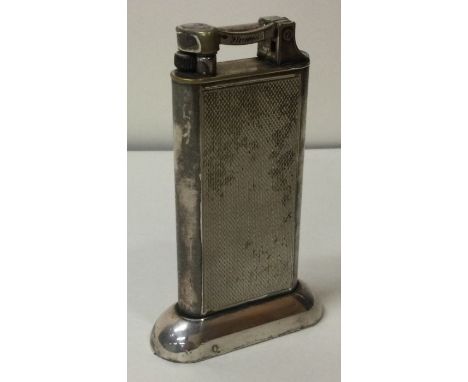 A large Dunhill plated lighter. Approx. 200 grams. Est. £80 - £120.