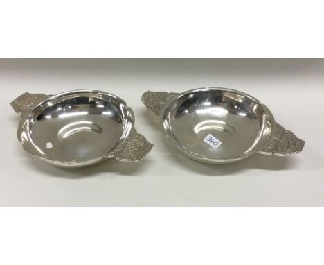 An unusual pair of silver quaiches engraved with flowers to handles. London 1937. By R E Stone. Signed by maker. Approx. 179 