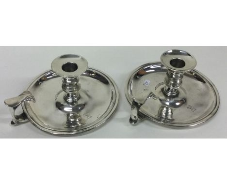 An 18th Century pair of silver chambersticks. London 1757. By William Cafe. Approx. 631 grams. Est. £1000 - £2000.