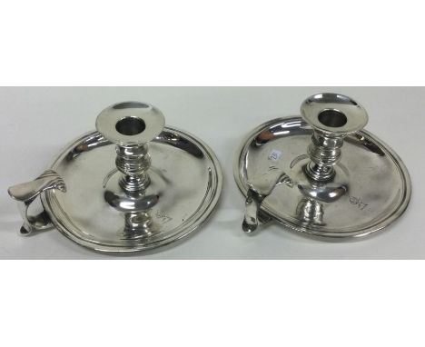 An 18th Century pair of silver chambersticks. London 1757. By William Cafe. Approx. 631 grams. Est. £1000 - £2000.