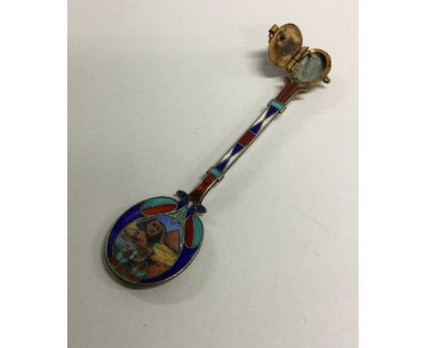 An unusual silver and enamel hinged spoon decorated with a pyramid scene. Approx. 9 grams. Est. £60 - £80.