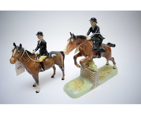 A Beswick model of a lady hunter in black coat, 19cms high; and a lady hunter on Bay Horse jumping a fence, 26 x 24cms high.