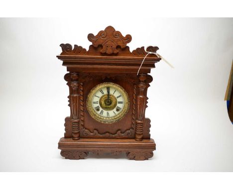 An early 20th Century oak cased American mantel clock, the movement by Ansonia Clock Co., New York, chiming on a coil, 48cms 