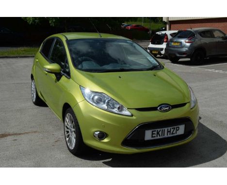 A green Ford Fiesta 1.4 Titanium Auto, automatic petrol car, 5 door hatchback, upholstered in plain and patterned fabric, reg