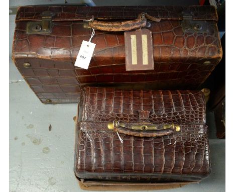 An early 20th Century crocodile skin travel trunk, with monogram initials 'C.B.', 35cms wide; together with an alligator skin