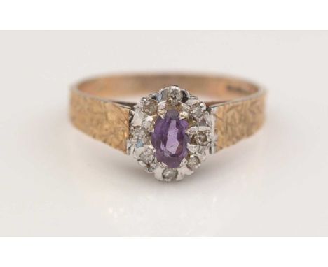 An amethyst and diamond cluster ring, the central oval facet-cut amethyst surrounded by eight 8-cut diamonds in illusion sett